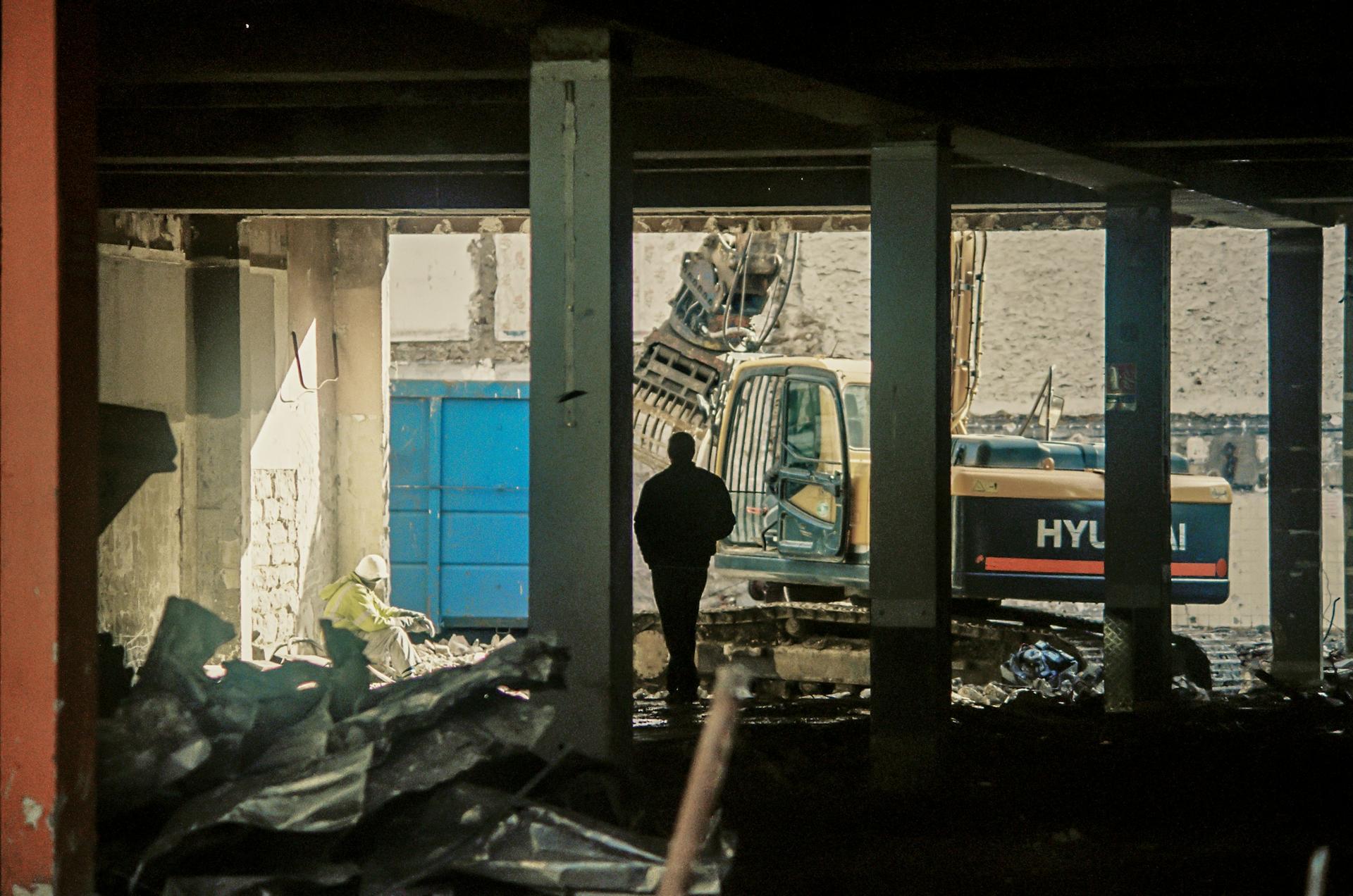 A worker looking out over a demolition project