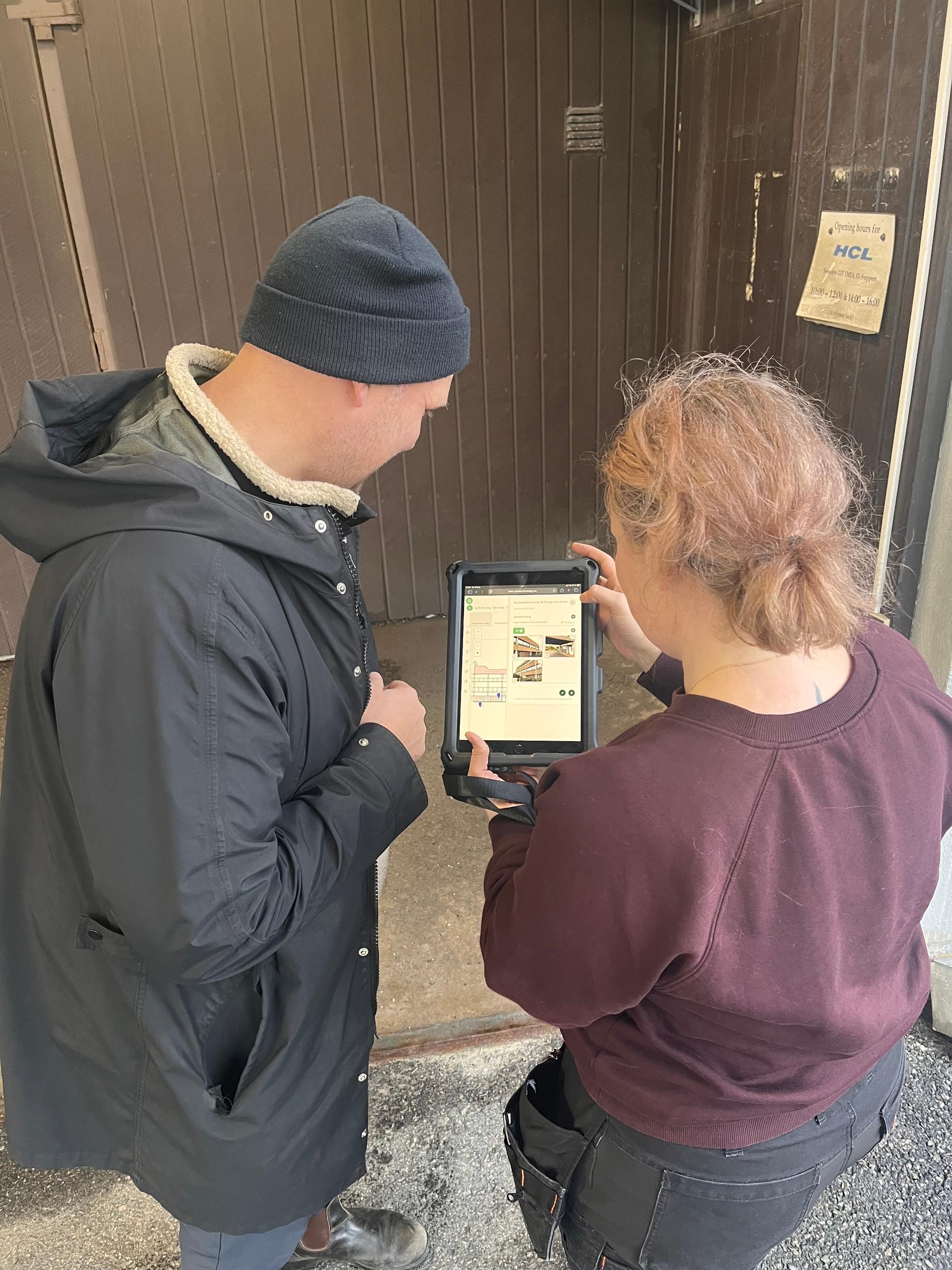 Two people looking at MIRA on an iPad